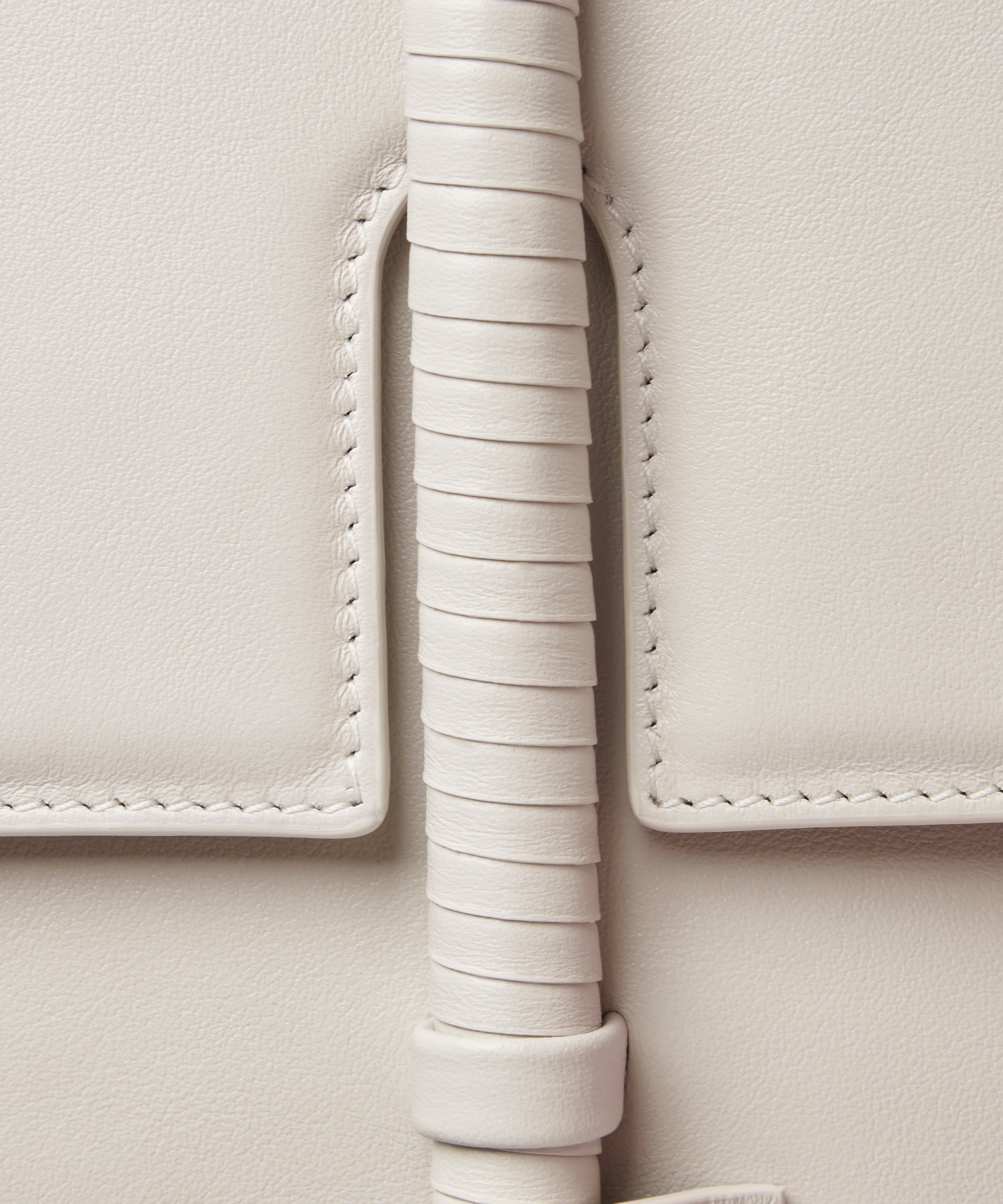 KUN HONG the CHUA collection Handbags Mother Satchel Daughter Mini  Close-up of a light gray leather handbag with decorative leather wrapping detail.