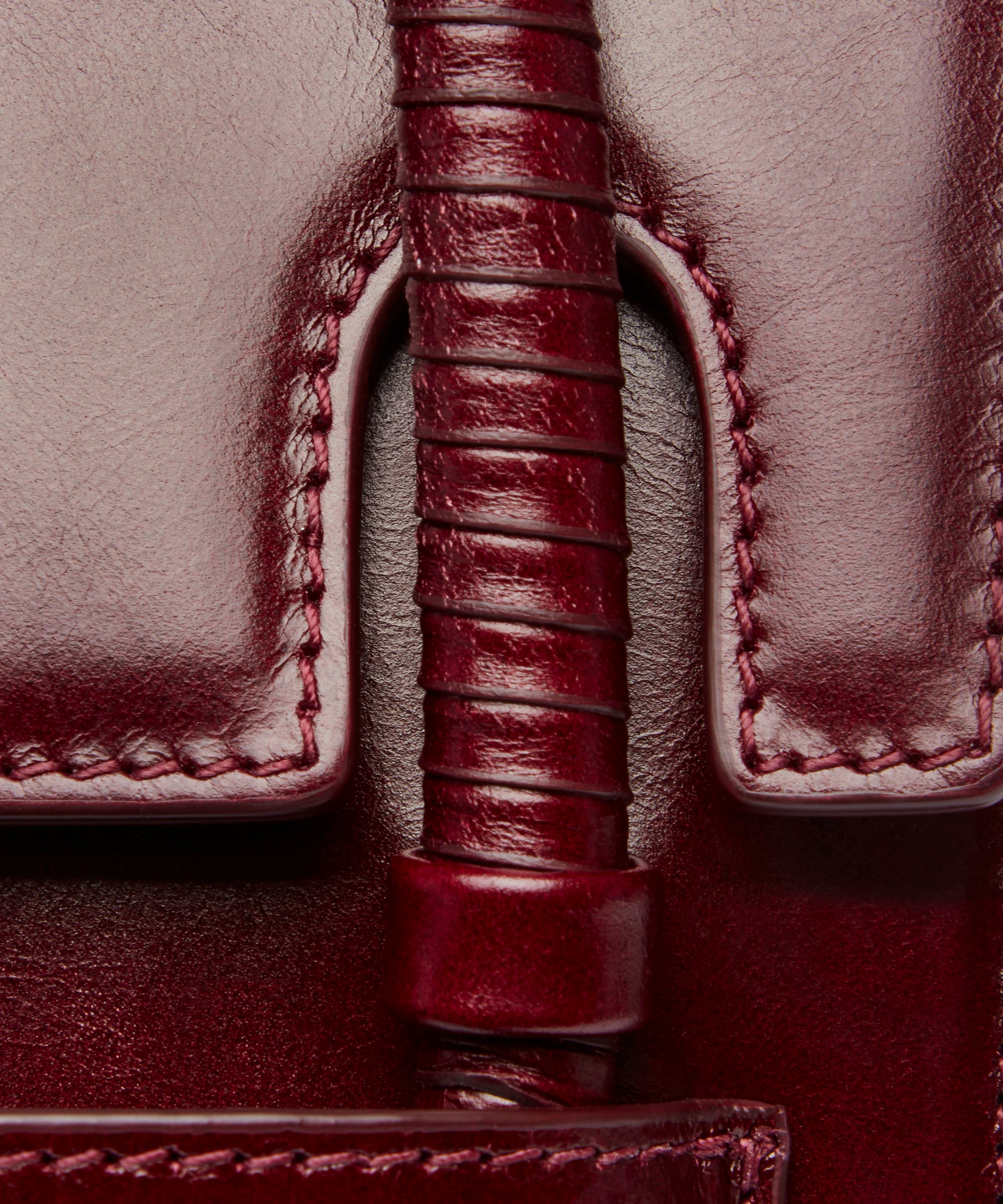 KUN HONG the CHUA collection Handbags Mother Satchel Daughter Mini Close-up of a burgundy leather handle and stitching details on a bag.