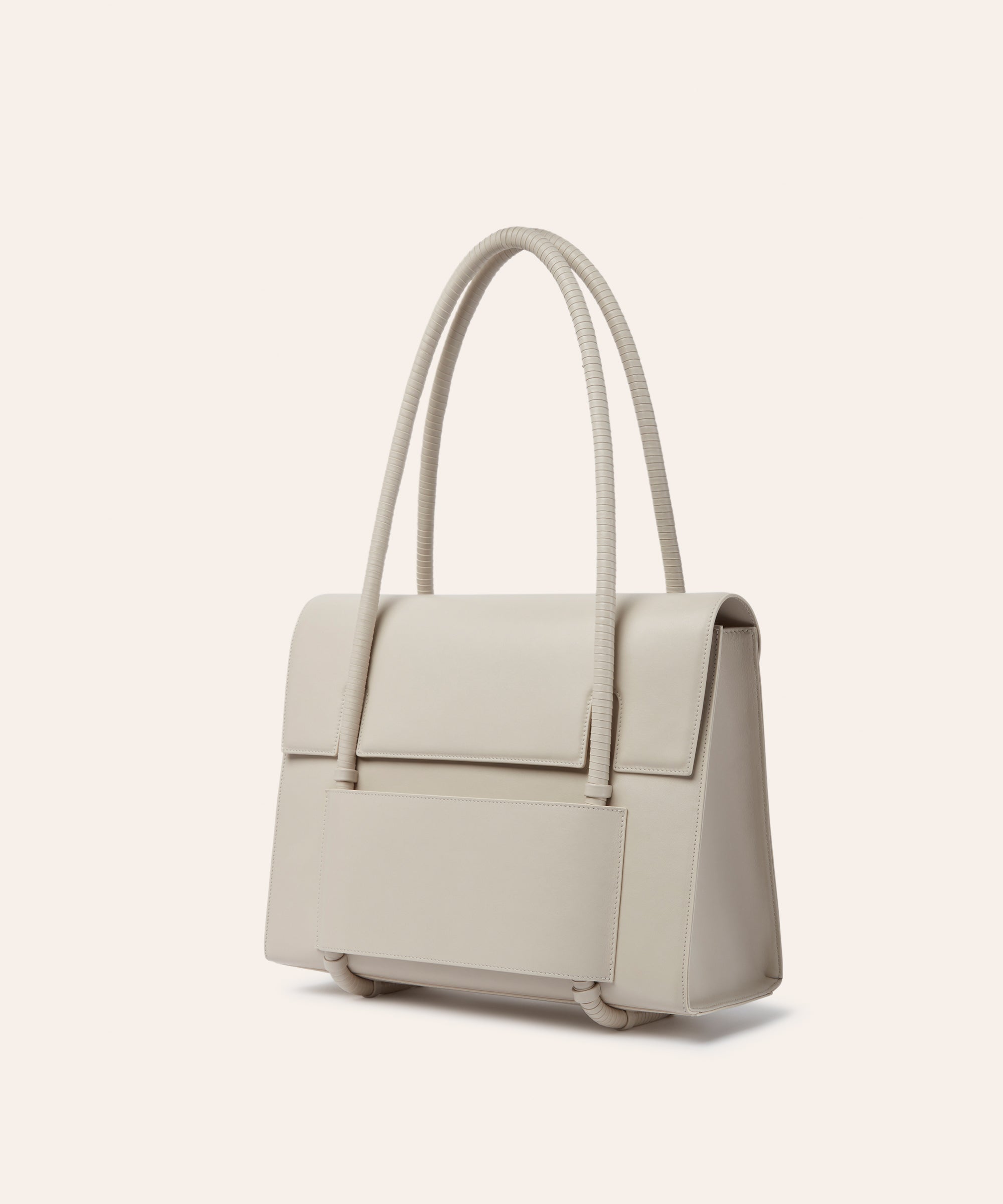 KUN HONG the CHUA collection Handbags Mother Satchel Daughter Mini  in colorway pearl, Beige white handbag with leather wrapped handles, double strap on a beige background